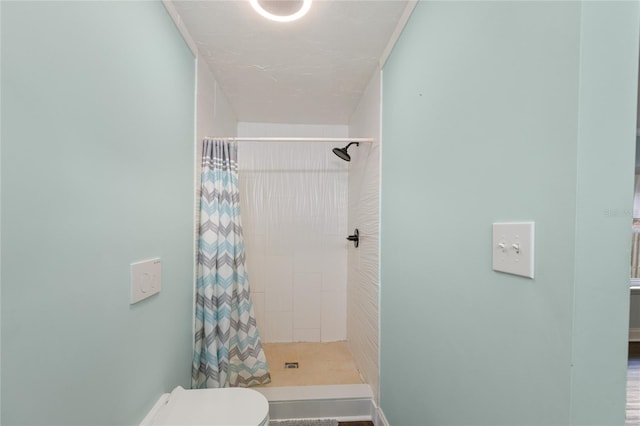 bathroom with toilet and walk in shower