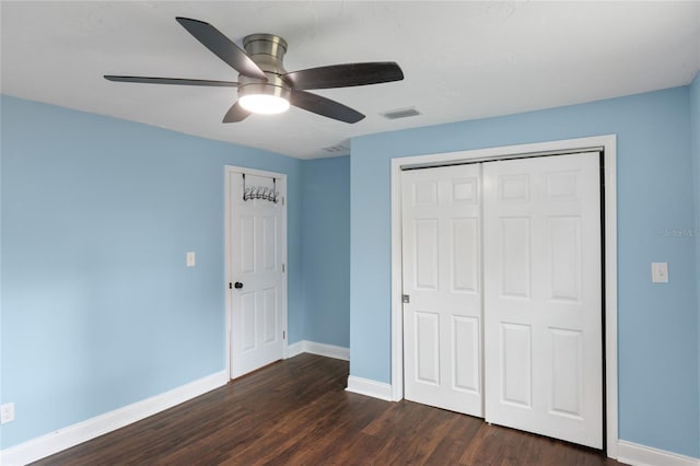 unfurnished bedroom with a closet, ceiling fan, and dark wood-type flooring