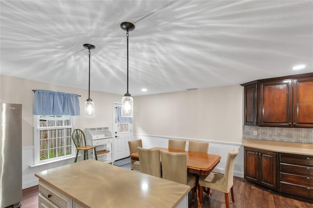 dining space with dark hardwood / wood-style flooring