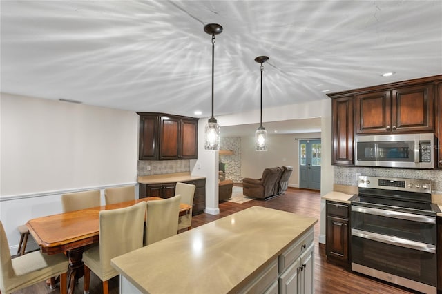 kitchen featuring backsplash, appliances with stainless steel finishes, dark hardwood / wood-style floors, and dark brown cabinetry