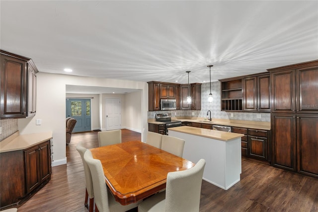 dining room with sink and dark hardwood / wood-style floors