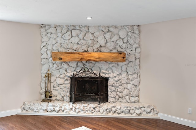 details featuring a large fireplace and hardwood / wood-style flooring