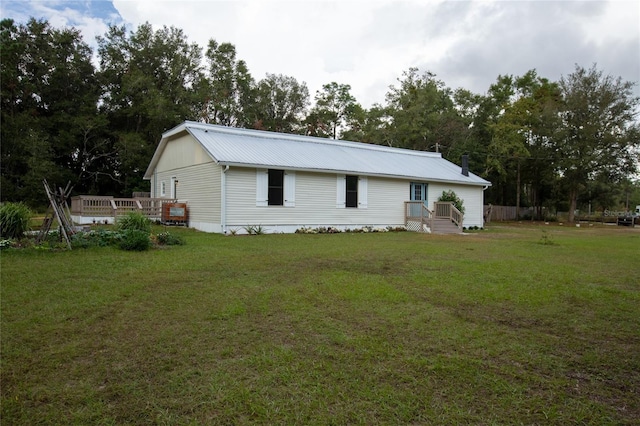 exterior space with a wooden deck and a front lawn