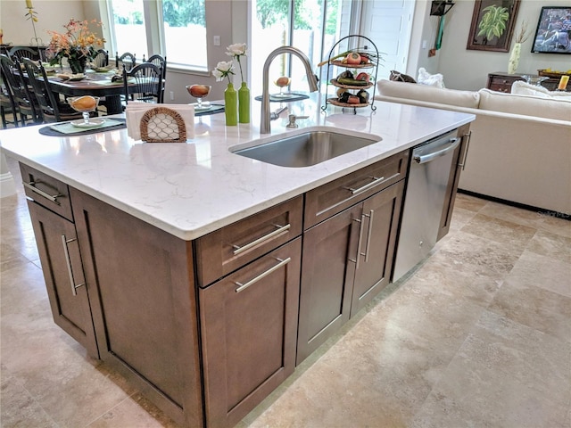 6475 SW 74th Dr, Gainesville, FL 32608 - kitchen featuring a sink, open floor plan, stainless steel dishwasher, a kitchen island with sink, and light stone counters