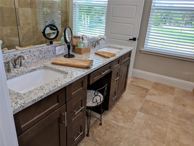 6475 SW 74th Dr, Gainesville, FL 32608 - full bathroom featuring baseboards, tiled shower, and double vanity