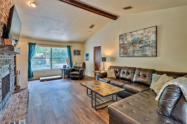 living room with a brick fireplace, lofted ceiling with beams, and hardwood / wood-style flooring