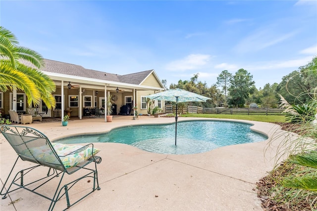 view of pool with a patio and ceiling fan