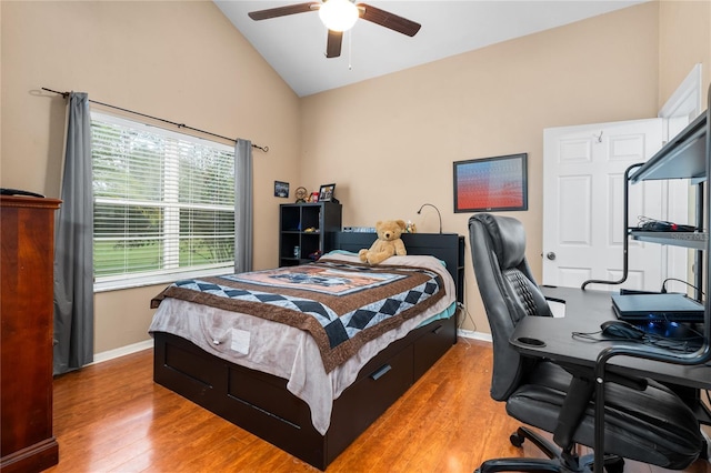 bedroom featuring light wood-style flooring, baseboards, a desk, high vaulted ceiling, and ceiling fan