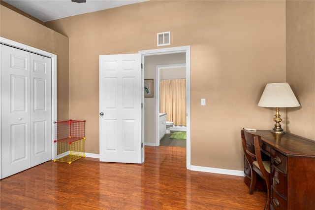 bedroom with wood-type flooring and a closet