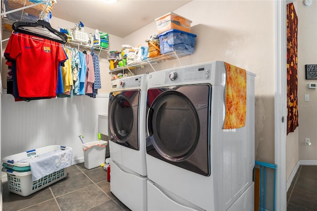 clothes washing area featuring dark tile patterned floors and independent washer and dryer