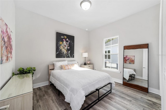 bedroom with hardwood / wood-style flooring