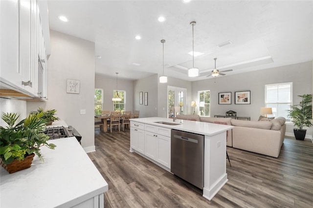 1035 NW 132nd Blvd, Newberry, FL 32669 - kitchen featuring dishwasher, a sink, light countertops, a raised ceiling, and white cabinetry