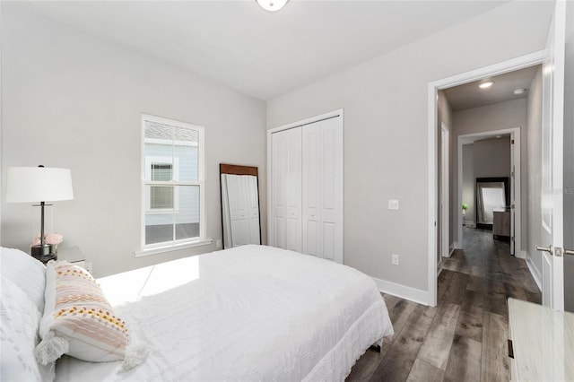 bedroom with a closet and dark hardwood / wood-style floors