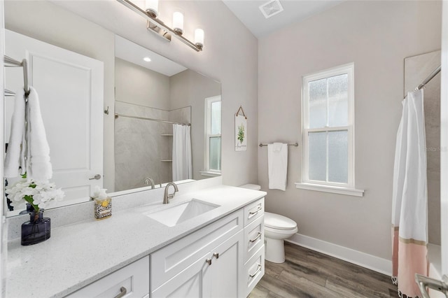 bathroom with wood-type flooring, toilet, vanity, and a shower with shower curtain