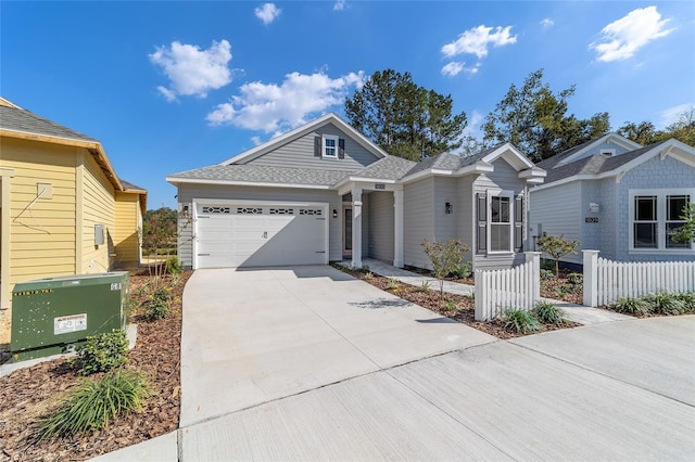 1035 NW 132nd Blvd, Newberry, FL 32669 - view of front facade with an attached garage, driveway, fence, and a shingled roof