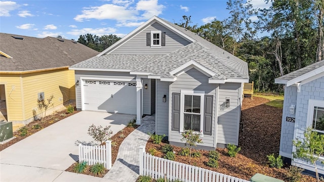1035 NW 132nd Blvd, Newberry, FL 32669 - view of front facade with concrete driveway, fence, an attached garage, and roof with shingles