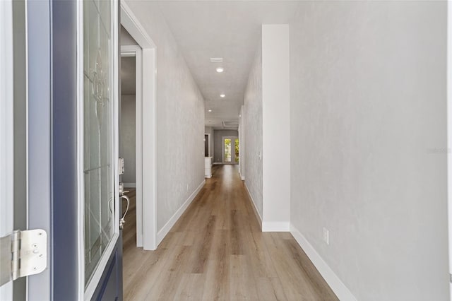 hallway with light wood-type flooring