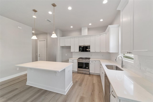 1029 NW 132nd Blvd, Newberry, FL 32669 - kitchen featuring stainless steel appliances, a sink, light wood finished floors, white cabinetry, and recessed lighting