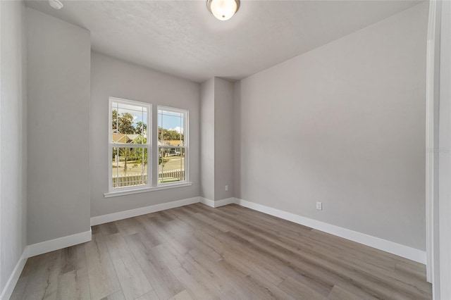 spare room featuring light hardwood / wood-style floors