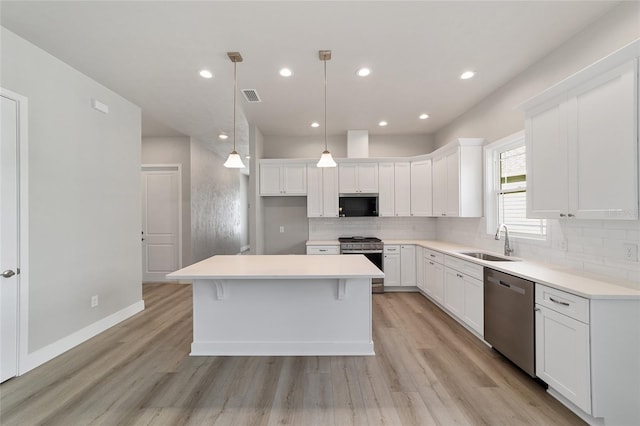 1029 NW 132nd Blvd, Newberry, FL 32669 - kitchen featuring stainless steel appliances, a sink, light wood finished floors, tasteful backsplash, and recessed lighting