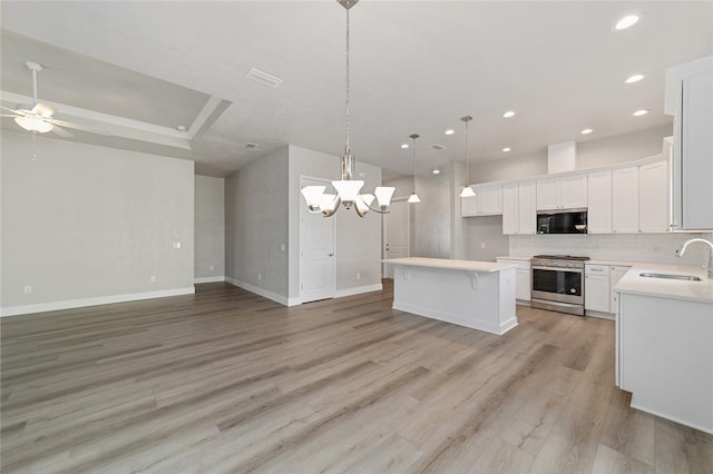 1029 NW 132nd Blvd, Newberry, FL 32669 - kitchen featuring gas range, black microwave, a sink, open floor plan, and recessed lighting