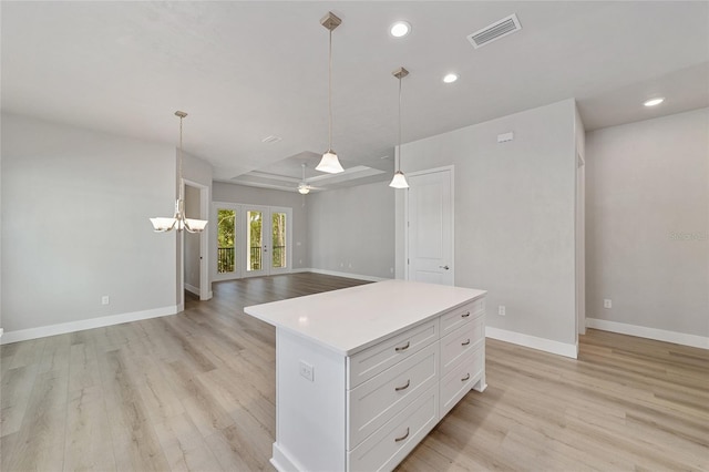 1029 NW 132nd Blvd, Newberry, FL 32669 - kitchen featuring light wood-style flooring, open floor plan, baseboards, light countertops, and white cabinets