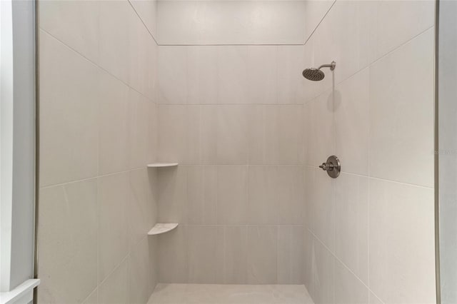 bathroom with a tile shower