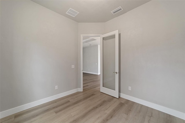 spare room featuring light hardwood / wood-style flooring