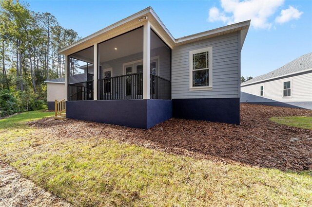 1029 NW 132nd Blvd, Newberry, FL 32669 - rear view of property featuring a sunroom and a yard