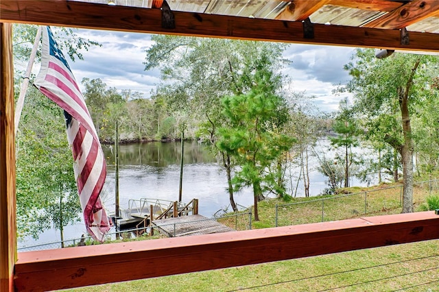 exterior space with a water view and a boat dock