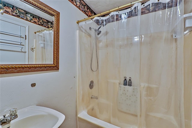 full bath featuring a sink and shower / tub combo with curtain