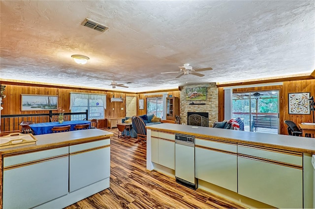 7890 SW 25th Pl, Bell, FL 32619 - kitchen with a ceiling fan, wood walls, wood finished floors, a fireplace, and a textured ceiling