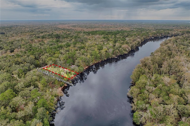 aerial view with a wooded view and a water view