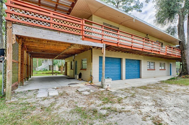 view of side of home featuring an attached garage