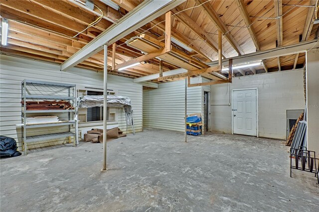 below grade area with concrete block wall and a garage