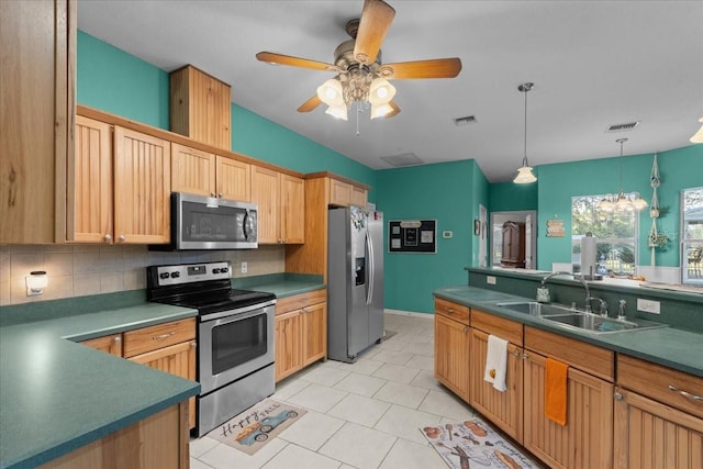 kitchen with ceiling fan, sink, tasteful backsplash, light tile patterned floors, and appliances with stainless steel finishes