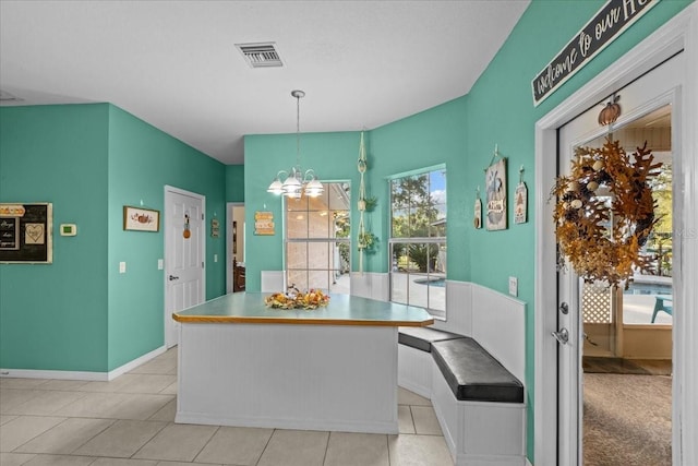 dining space featuring breakfast area, an inviting chandelier, a wealth of natural light, and light tile patterned flooring