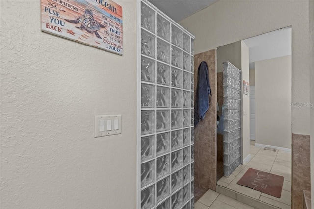 bathroom featuring tile patterned floors and walk in shower