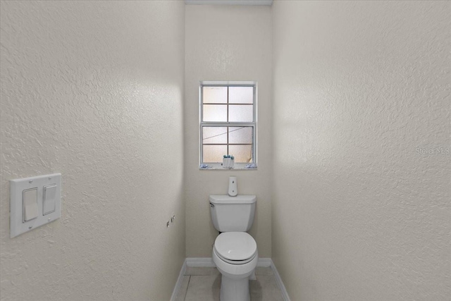 bathroom featuring tile patterned floors and toilet