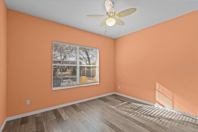 spare room with wood-type flooring and ceiling fan