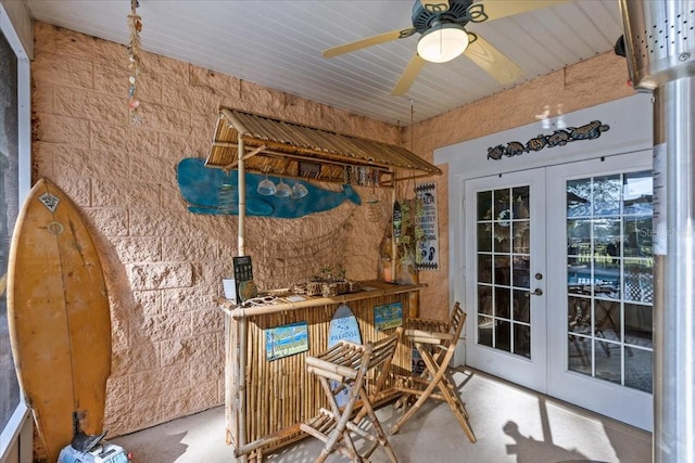 interior space with ceiling fan and french doors