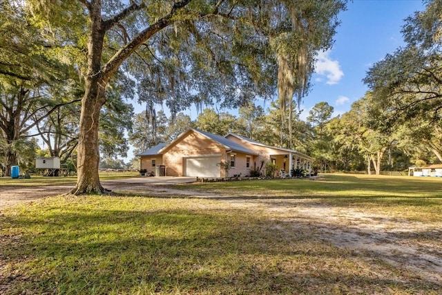 view of side of property featuring a garage and a lawn