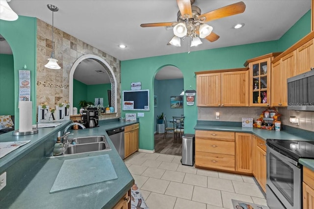 kitchen featuring ceiling fan, sink, stainless steel appliances, pendant lighting, and light tile patterned floors