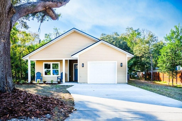 single story home featuring concrete driveway, fence, and an attached garage