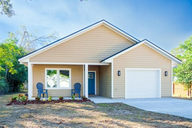 view of front of house with a garage, covered porch, and concrete driveway