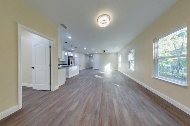 unfurnished living room featuring dark hardwood / wood-style flooring