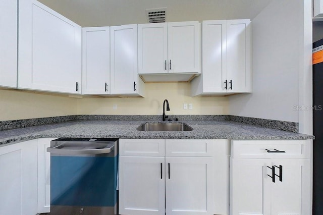 kitchen with dishwasher, white cabinets, and sink