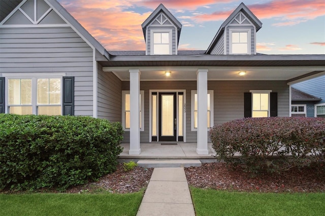 exterior entry at dusk with covered porch