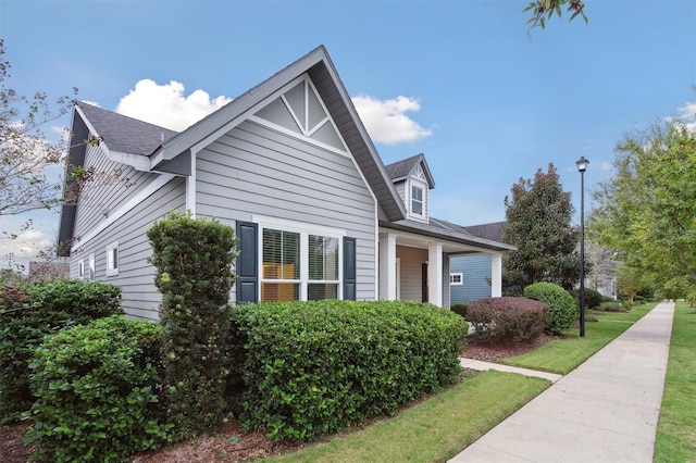 view of side of home with a lawn