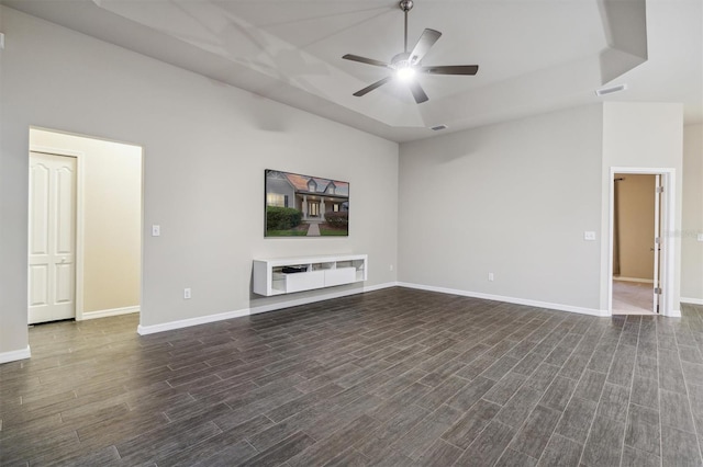 unfurnished living room featuring a high ceiling, dark hardwood / wood-style floors, and ceiling fan